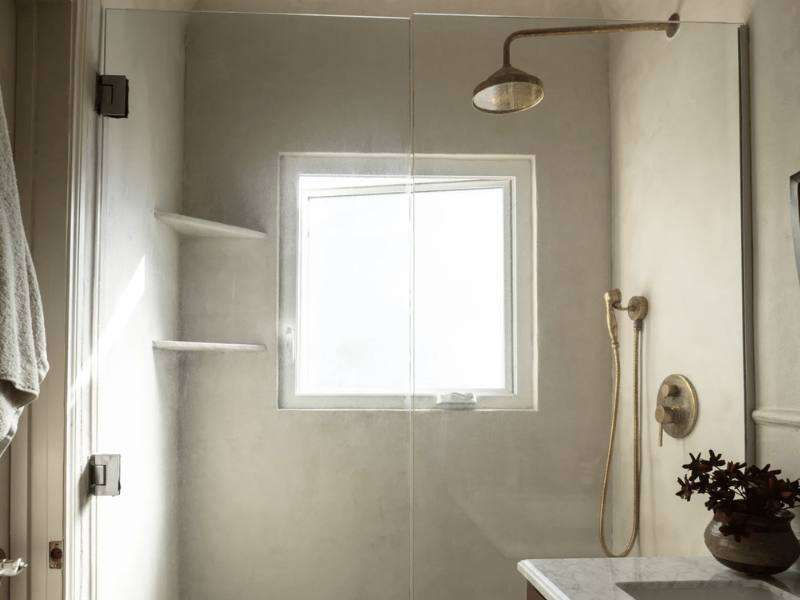 View of LoneFoxHome shower redesigned with Meoded Concretta plaster in a neutral tone, creating a modern, timeless, and spa-like atmosphere with smooth, seamless surfaces and calming color.

