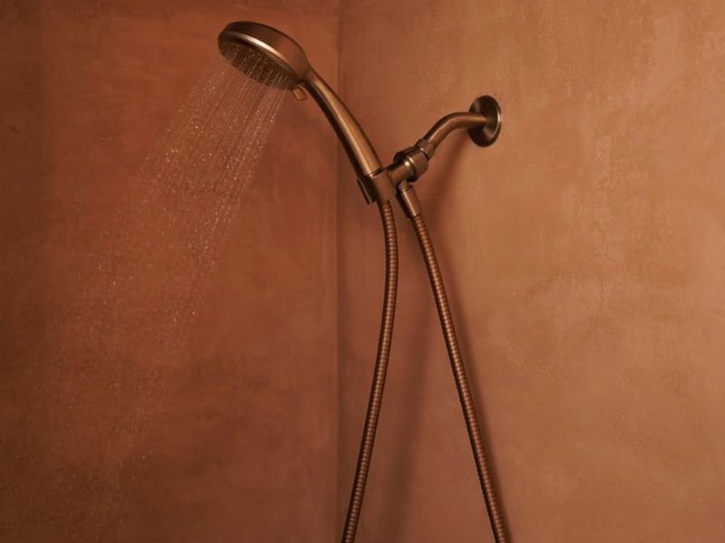 warm lighting on microcement bathroom walls